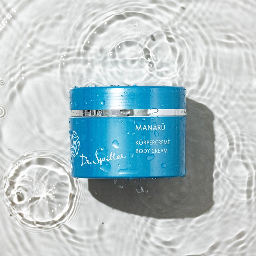 MANARU body cream lies in clear water
