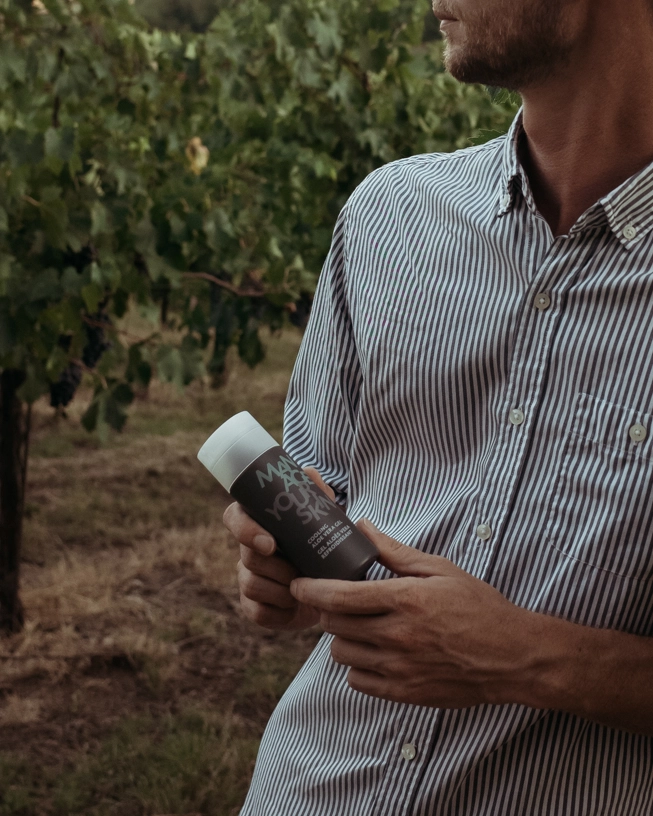 Man with shirt holds the Cooling Aloe Vera Gel in his hand
