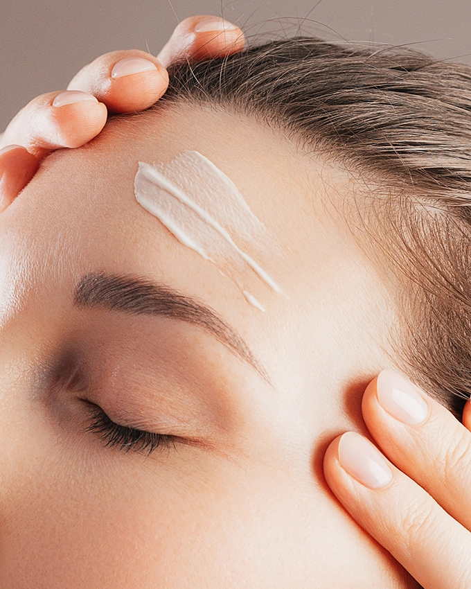 Woman applies Trawenmoor face cream to her face