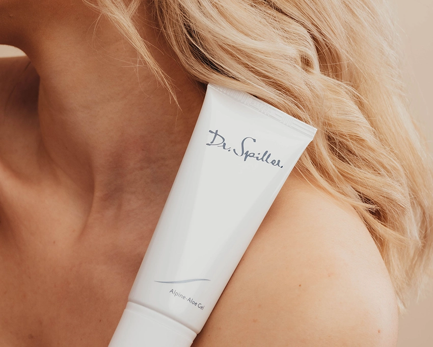 Alpine Aloe Gel lies on the shoulder of a woman with blonde hair