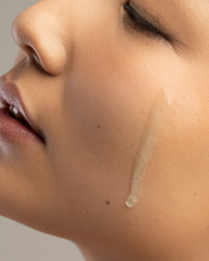 Thin serum flows onto woman's cheek