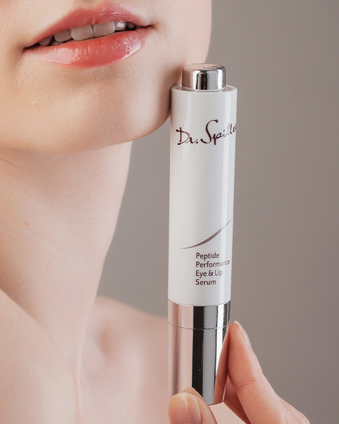 Peptide Performance Eye & Lip Serum is held on the chin