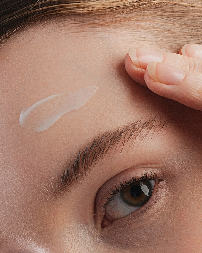 Serum is applied to a woman's forehead