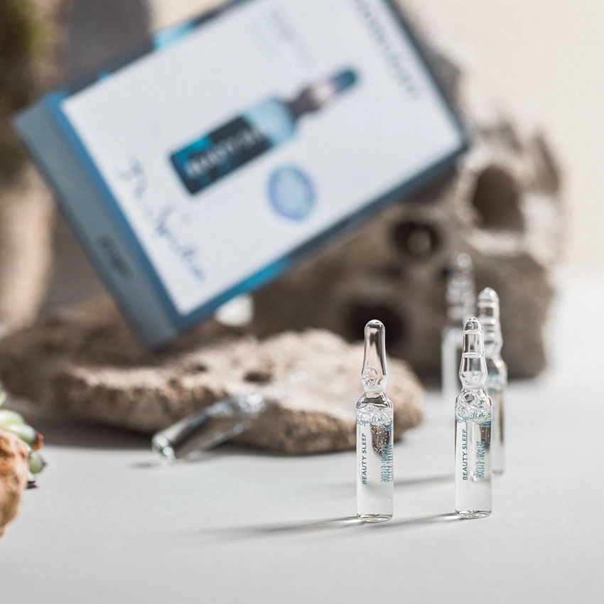 Face ampoules on decorative background