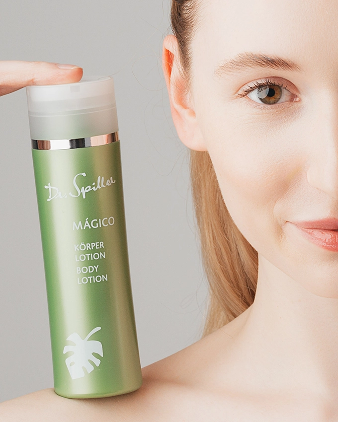 Magico body lotion stands on woman's shoulder
