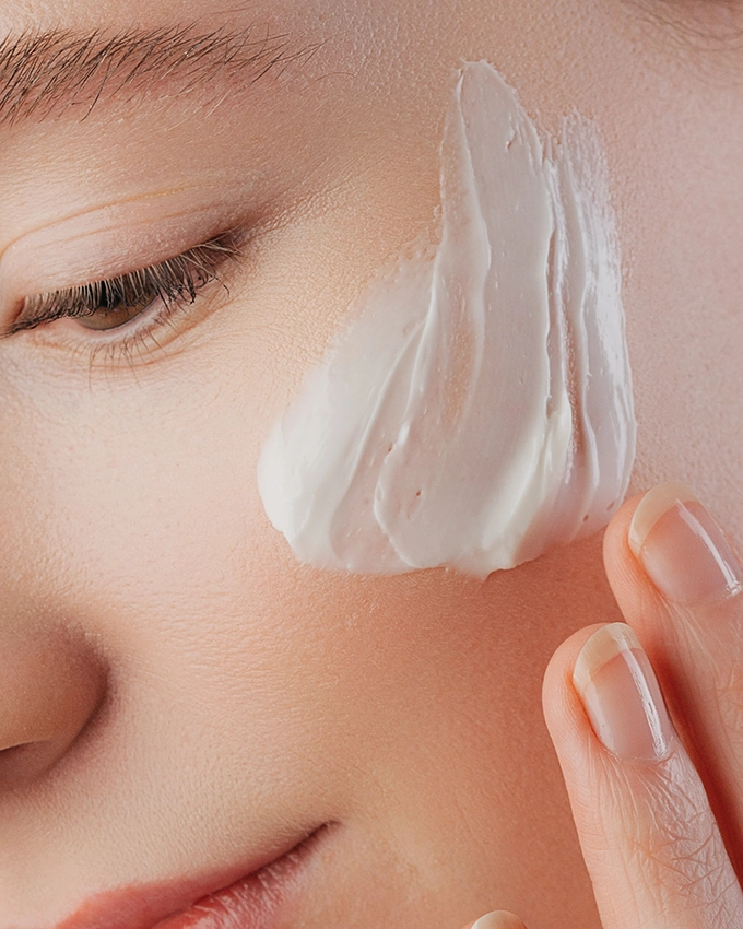 Face cream application on the cheek