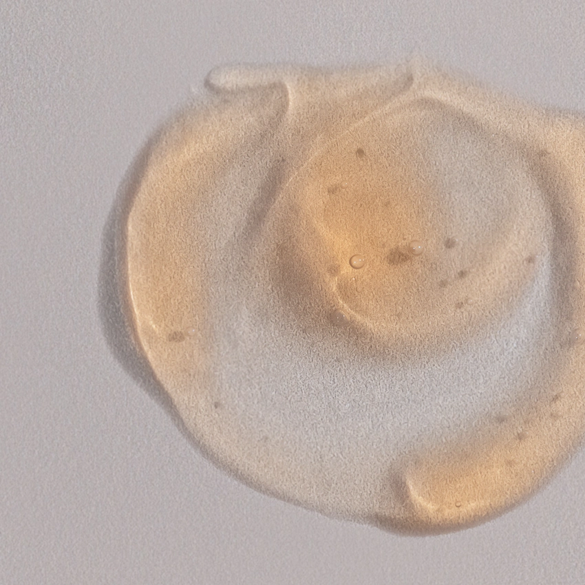 Close-up texture - semi-transparent, orangey, gel-like serum