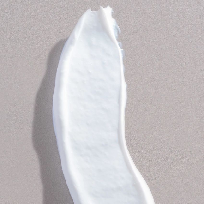 Close-up texture - white jojoba exfoliating cream with exfoliating grains