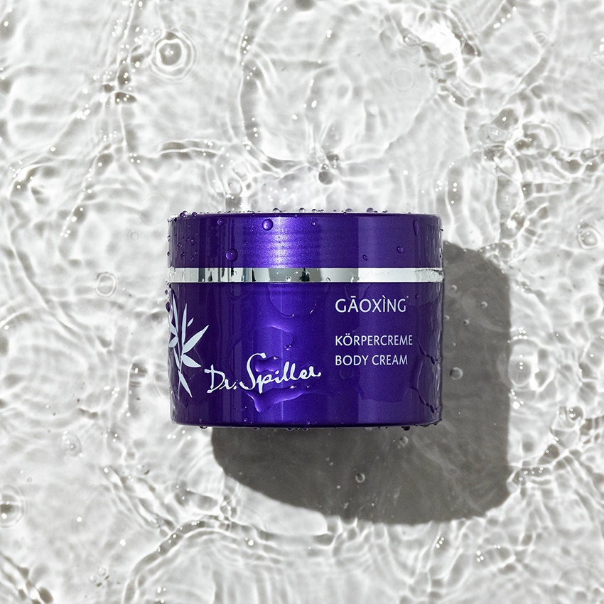 Gaoxing Körpercreme liegt auf klarem Wasser