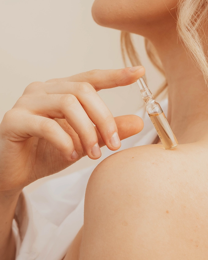 Woman holding a face ampoule