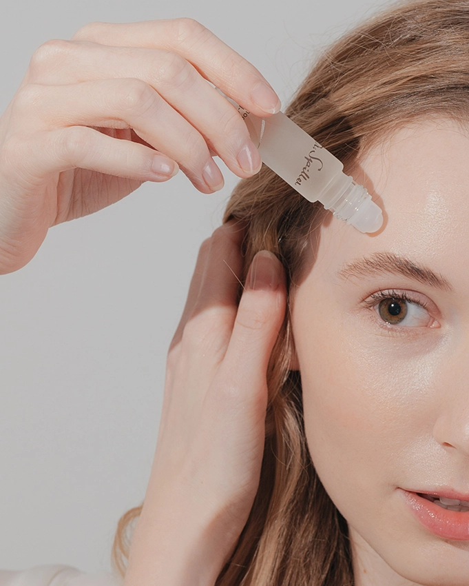 Acnoderm Roll-On is applied to a woman's skin